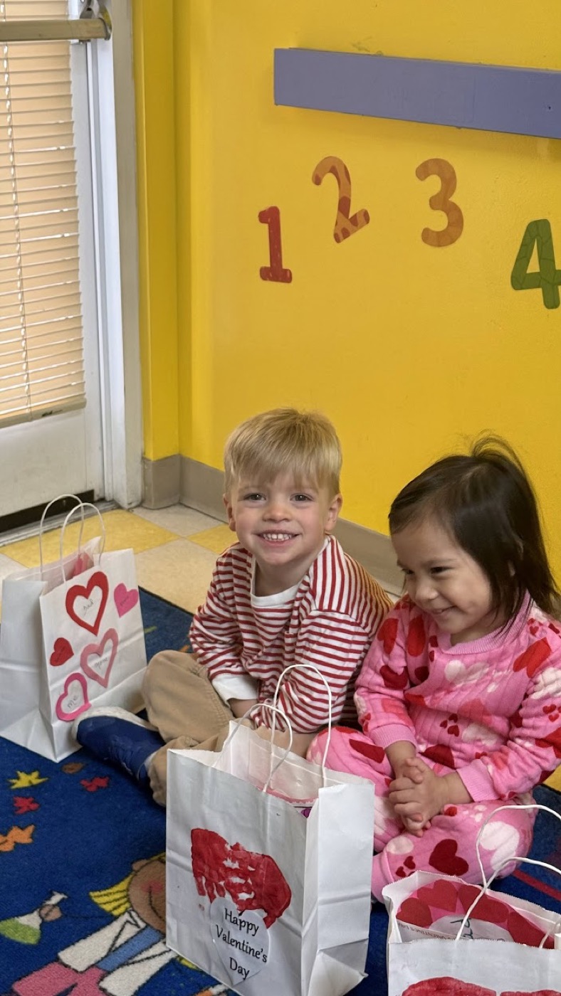 Young preschool children smiling during a classroom activity