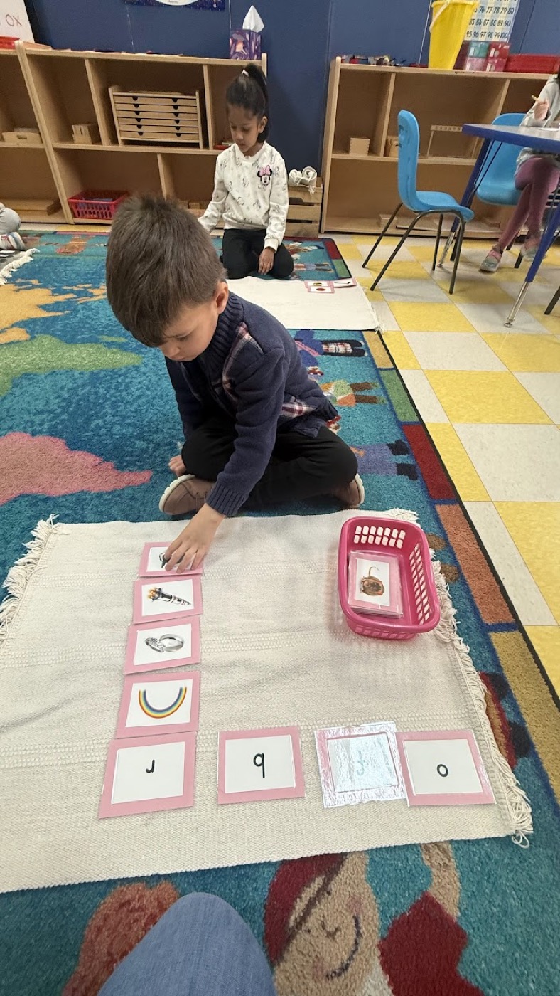 Child matching language cards during Montessori classroom work